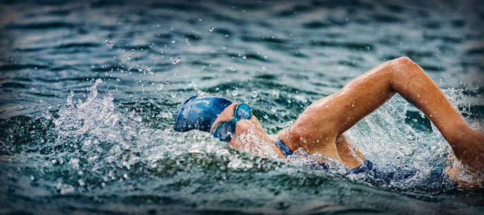 Woman doing an open water swy=im