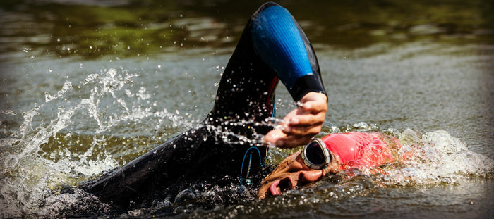 ironman triathlete training in lake