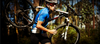 Mountain biker carrying bicycle in forest