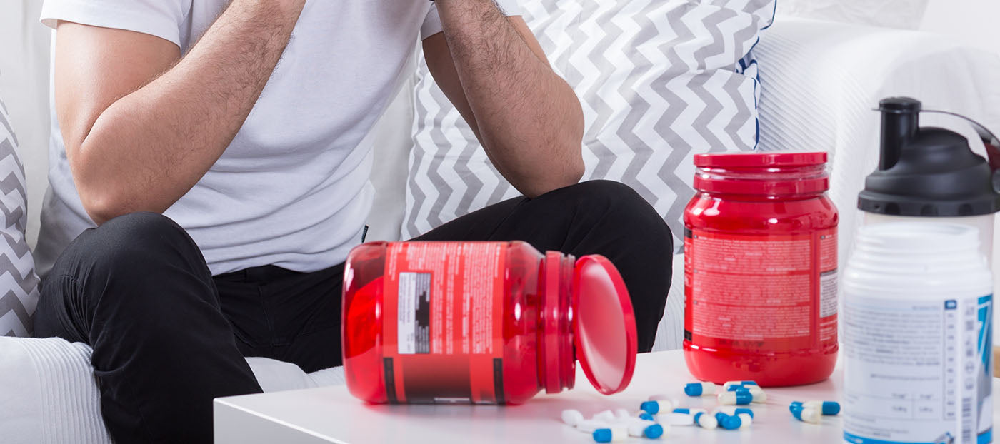 man taking fitness supplements