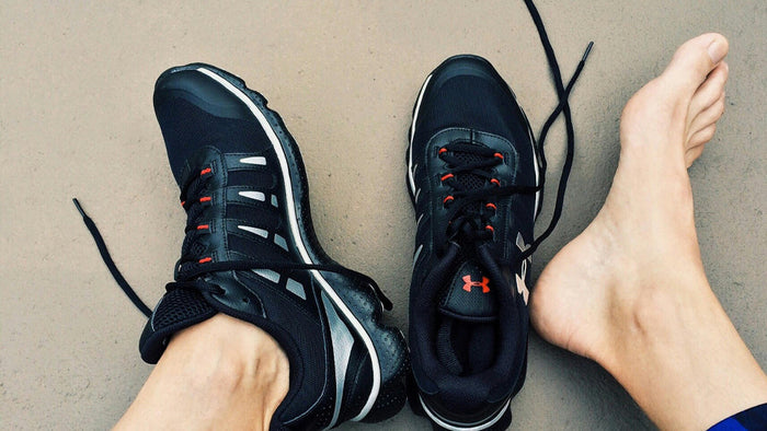 image of someone's feet, one with a shoe and one out of the shoe