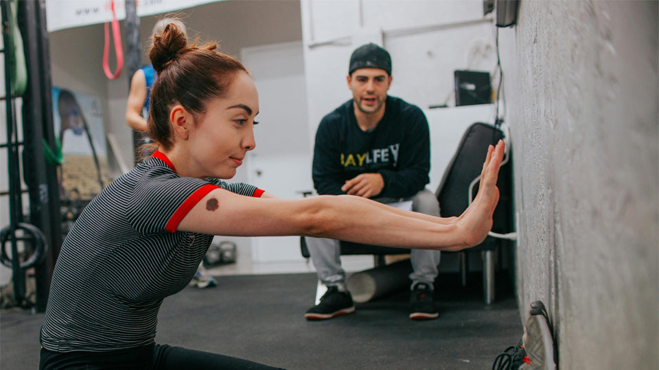 a woman training in a gym with her coach